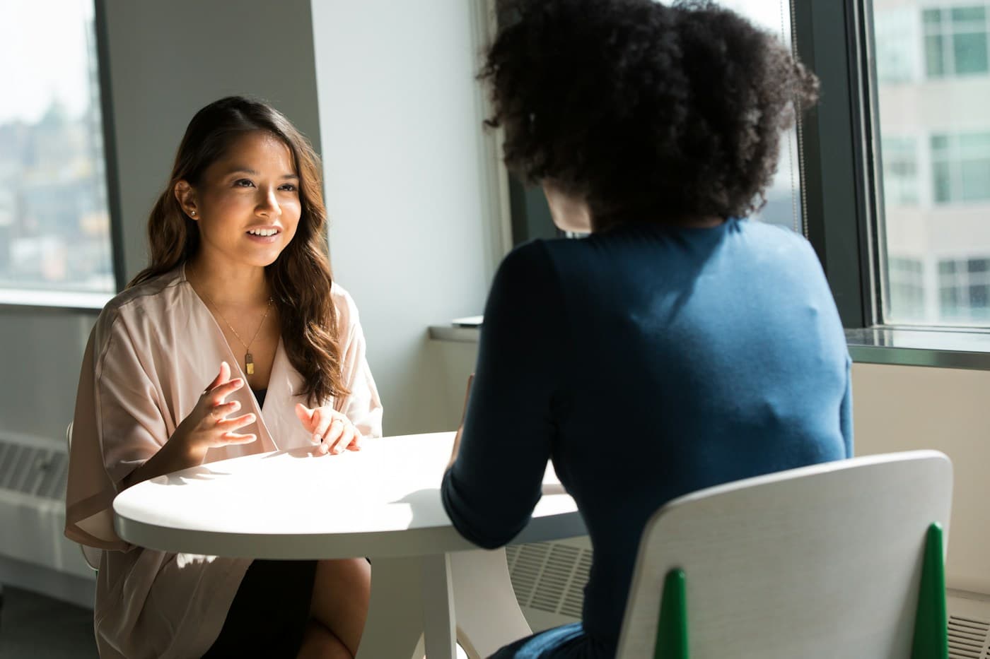 Two people having an attentive conversation across a table